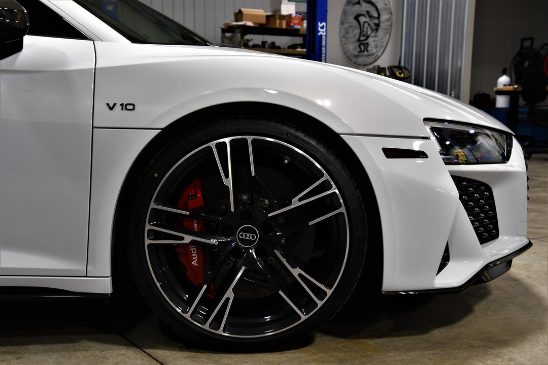 Close-up of a detailed supercar wheel and brake caliper